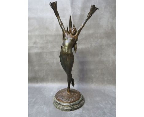 A BRONZE ART NOUVEAU FIGURAL TABLE LAMP BY FIRMIN BATE, the arms outstretched holding cornucopia shaped bayonet holders, sign