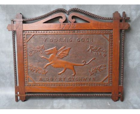 A 19TH CENTURY WELSH OAK FOLK ART PANEL DEPICITNG A DRAGON, with decorative surround, overall 47 x 61 cm