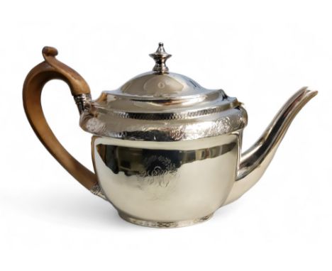 A George III silver boat shaped teapot, engraved and chased with band of foliage, spire finial, 15.5cm high,&nbsp;John Eames,