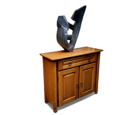 A small Arts &amp; Crafts style oak console, long drawer to frieze above two cupboards, opening tonreveal single shelf, 75cm 