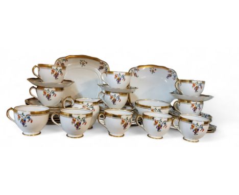 A Rosyln China Carnival pattern tea service, for twelve, comprising cups, saucers, side plates, two bread and butter plates, 