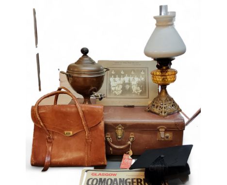 An early 20th century cast iron and glass oil lamp, c.1910;&nbsp; a copper samovar;&nbsp; &nbsp;a mid 20th century suitcase;&