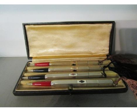 A set of four silver engine turned bridge pencils, boxed 