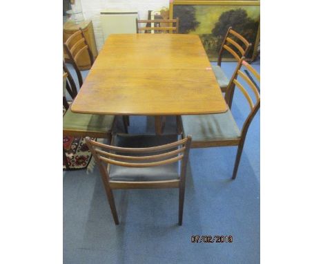 A G-Plan teak drop leaf table and six matching G-Plan chairs with ladder backs 