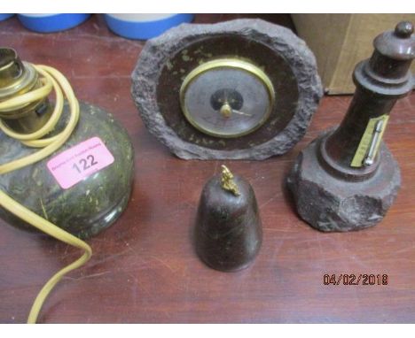 Four pieces of Cornish serpentine stone to include a lamp, a thermometer, a barometer and a paperweight 