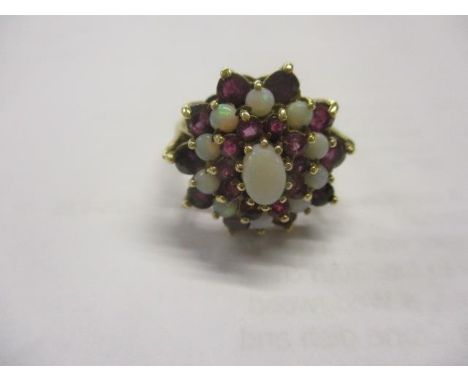 A 9ct gold, opal and ruby cluster ring 