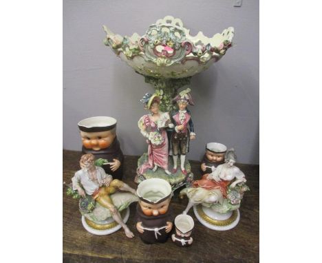 A mixed lot to include two Capodimonte figures signed Cappe, four Goebel monk jugs and a large decorative centrepiece 