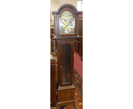 A contemporary mahogany long case clock, having a silvered and brass arched tempus fugit dial, glazed trunk door, with three 