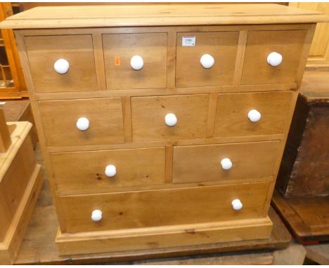 A modern pine low fitted side chest, with an arrangement of ten various drawers, width 76cm