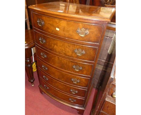 A contemporary figured walnut narrow bowfront chest of six long drawers, width 61cm