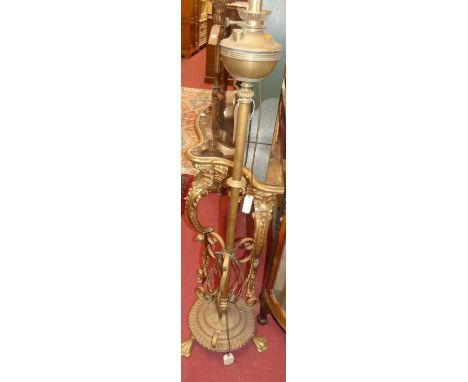 An Edwardian brass standard lamp, converted from a paraffin lamp, h.138cm (excluding fittings)