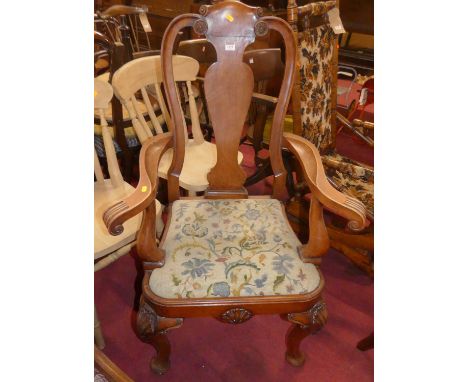 A Georgian style beech splat back open armchair, having floral tapestry needlework drop-in pad seat, on shell capped cabriole