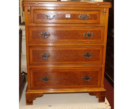 A contemporary figured walnut cross and feather banded fold-over bachelors chest, of four long graduated drawers, in the earl