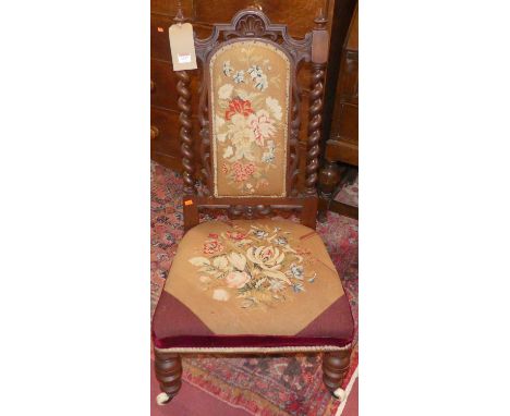 A mid-Victorian mahogany needlework tapestry pad back and seat prie dieu