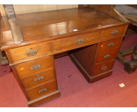 An Edwardian walnut twin pedestal writing desk, having typical arrangement of nine drawers, width 107cm