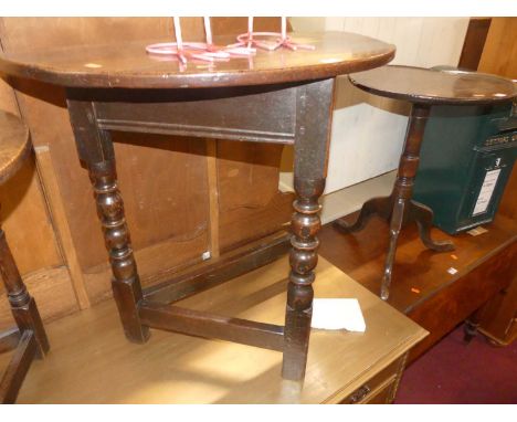 An 18th century provincial joined oak demi-lune side table, raised on bobbin turned and square cut supports united by lower s