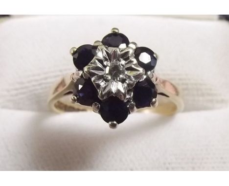 A 9 carat gold sapphire and diamond chip cluster ring