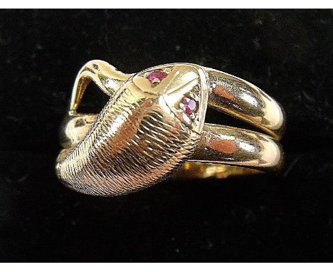 A 9 carat gold snake form ring set ruby eyes, 7g