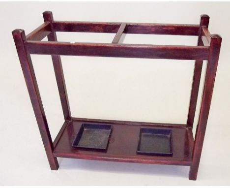 An Edwardian double mahogany stick stand