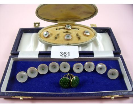 A set of mother of pearl and gilt buttons set green stones, a boxed set of four similar buttons and two green enamel buttons 