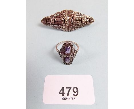 A silver amethyst and marcasite ring and a marcasite clip brooch 