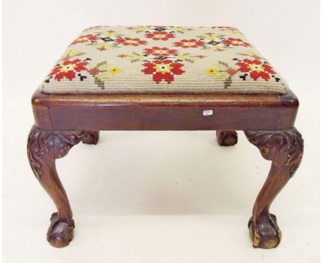 A Victorian floral tapestry stool on caved claw and ball feet
