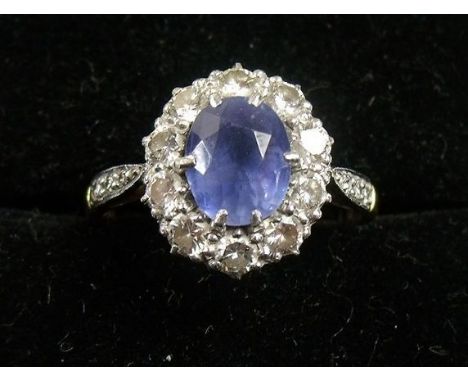 An 18 carat gold and platinum Ceylon sapphire and diamond cluster ring 