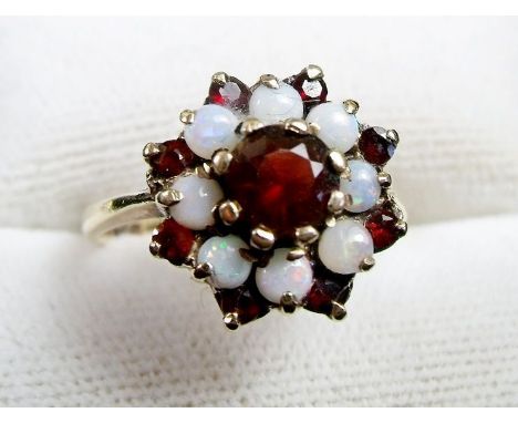 A 9 carat gold garnet and opal ring 