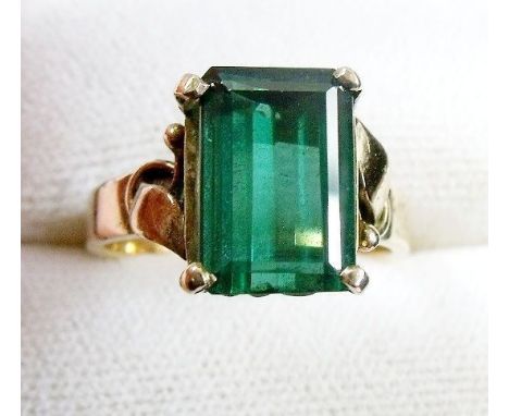 A 14 carat gold ring set step cut green/blue stone possibly a green topaz