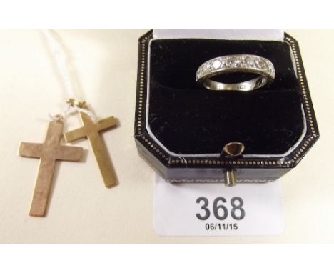 An 18 carat white gold ring set diamonds (three stones deficient), a 9 carat gold crucifix and a yellow metal crucifix 