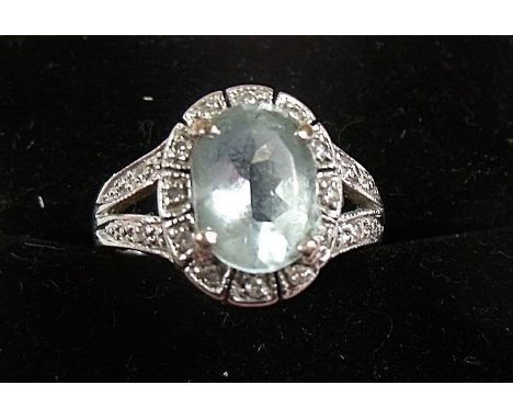 A 14 carat gold  aquamarine and diamond cluster ring 