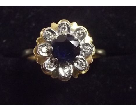 An 18 carat gold floral diamond and sapphire cluster ring