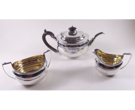 A silver three piece oval tea service, the sugar and milk jug with gilt interiors, London 1914, 30 ozs by C.S. Harris & Sons