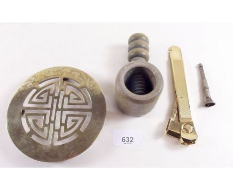 A cigar cutter, cigar piercer and a nut cracker 
