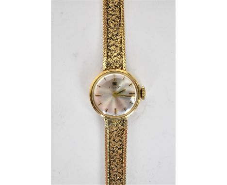 A vintage ladies 9ct gold cased Tissot manual wind wristwatch, having a silvered dial with baton hour markers, signed Tissot,