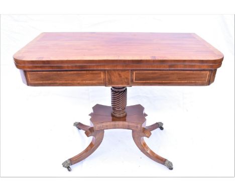 A William IV mahogany card table, circa 1830, the fold-over rectangular top on a turned and fluted pedestal on quatreform bas