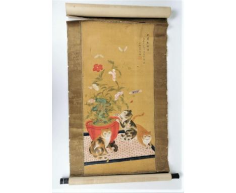 A Chinese hanging scroll painting on silk laid on paper, depicting cats, one playing with a flower from a red jardiniere on a