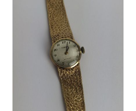 A vintage ladies 9ct gold cased manual wind Tissot wristwatch having a silvered dial, signed Tissot Stylist with Arabic numer