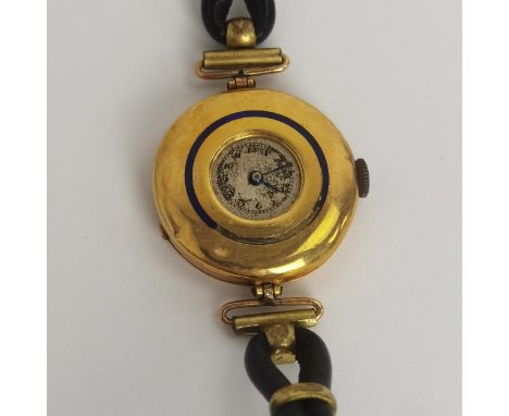 An early 20th century ladies 18ct gold cased manual wind wristwatch having a small round, worn dial with Arabic numerals and 
