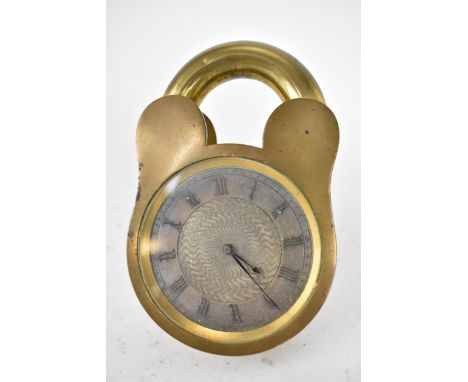 An early 20th century unusual bedside/travel clock in the form of a padlock in a brass case, the silvered dial having a machi