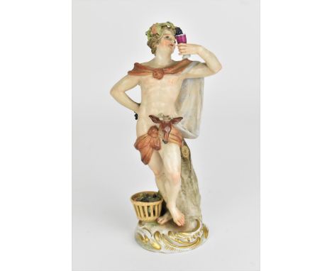 A late 19th century Meissen porcelain model of Bacchus, holding a goblet with a basket of grapes at his feet, raised on a scr