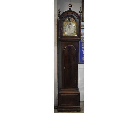 A George III mahogany cased 8 day longcase clock, having ball and spike finials and fluted pillars flanking the brass arched 