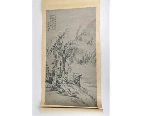 A Chinese hanging scroll ink painting, paper laid on silk, depicting a river landscape with trees, with calligraphy top left 