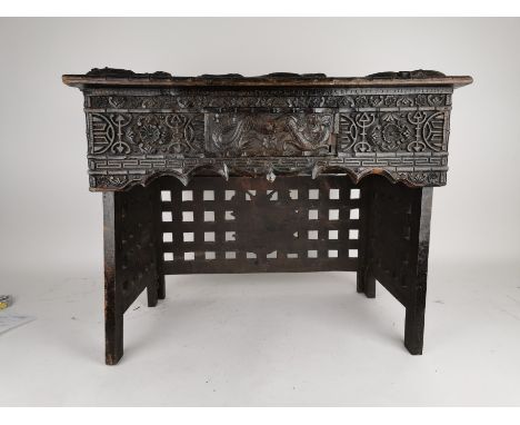 A late 19th/early 20th century Chinese carved hardwood folding travelling desk with single fitted drawer decorated with finel