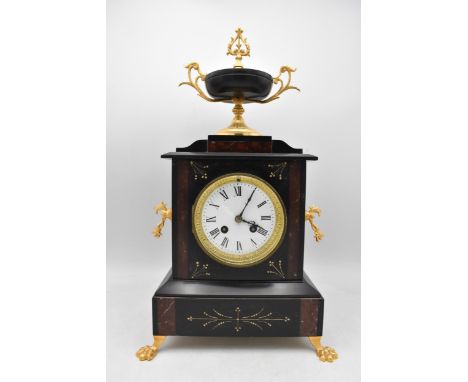 A late 19th century French marble mantle clock, having a twin gilt handled urn shaped finial, twin carrying handles and on tw