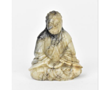 A Chinese Qianlong period carved chicken bone jade figure of Budha Shakamuni in seated lotus position, with bored square to t