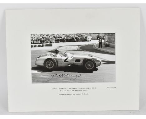 A signed reprinted photograph of Juan Manuel Fangio, racing a Mercedes Benz at the Grand Prix de Monaco 1955, photographed by