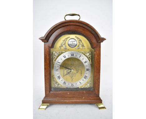 A late 20th century Garrard London mantel clock in a mahogany case, the brass arched top dial having silvered chapter ring, a