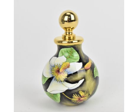 A Moorcroft Enamels Ltd perfume bottle with gilt stopper, designed by Philip Gibson and painted by E. Todd with white magnoli