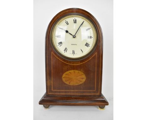 An early 20th century Zenith 8 day mantle clock in a mahogany arched top case with string banding, the dial having Roman nume